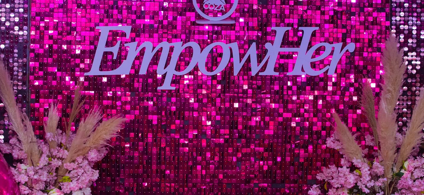 EmpowHer event backdrop with floral decorations